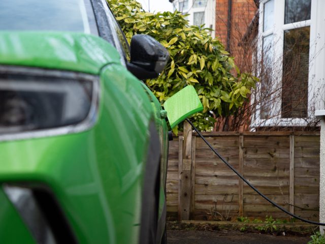 Green,Electric,Car,On,Charge,At,Home